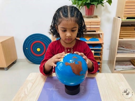 A child exploring a globe, discovering the wider world